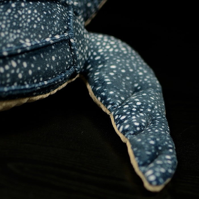 Close-up of the leatherback sea turtle plush's flipper, showcasing soft textures and realistic design