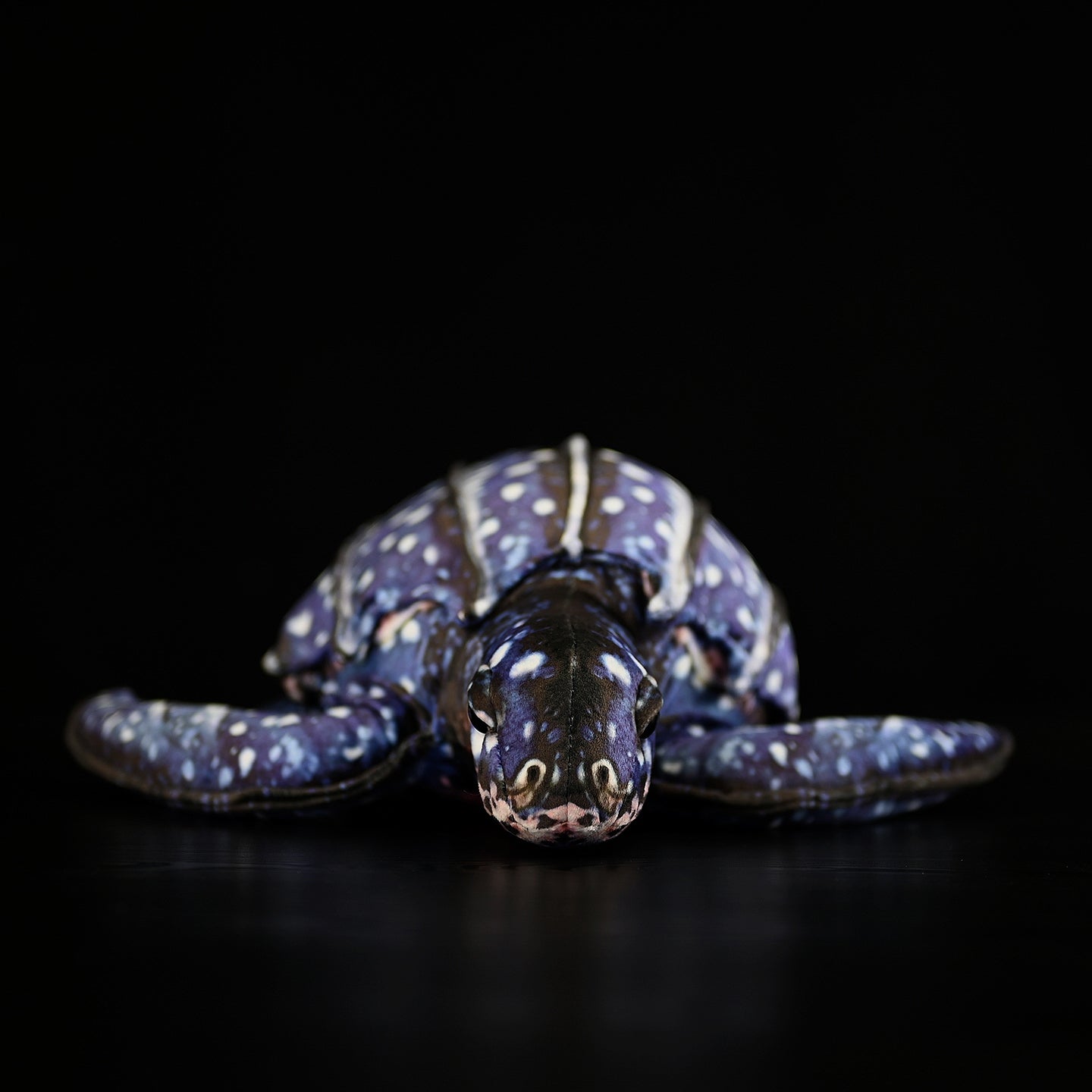 Front view of a lifelike leatherback sea turtle plush with intricate patterns and realistic design