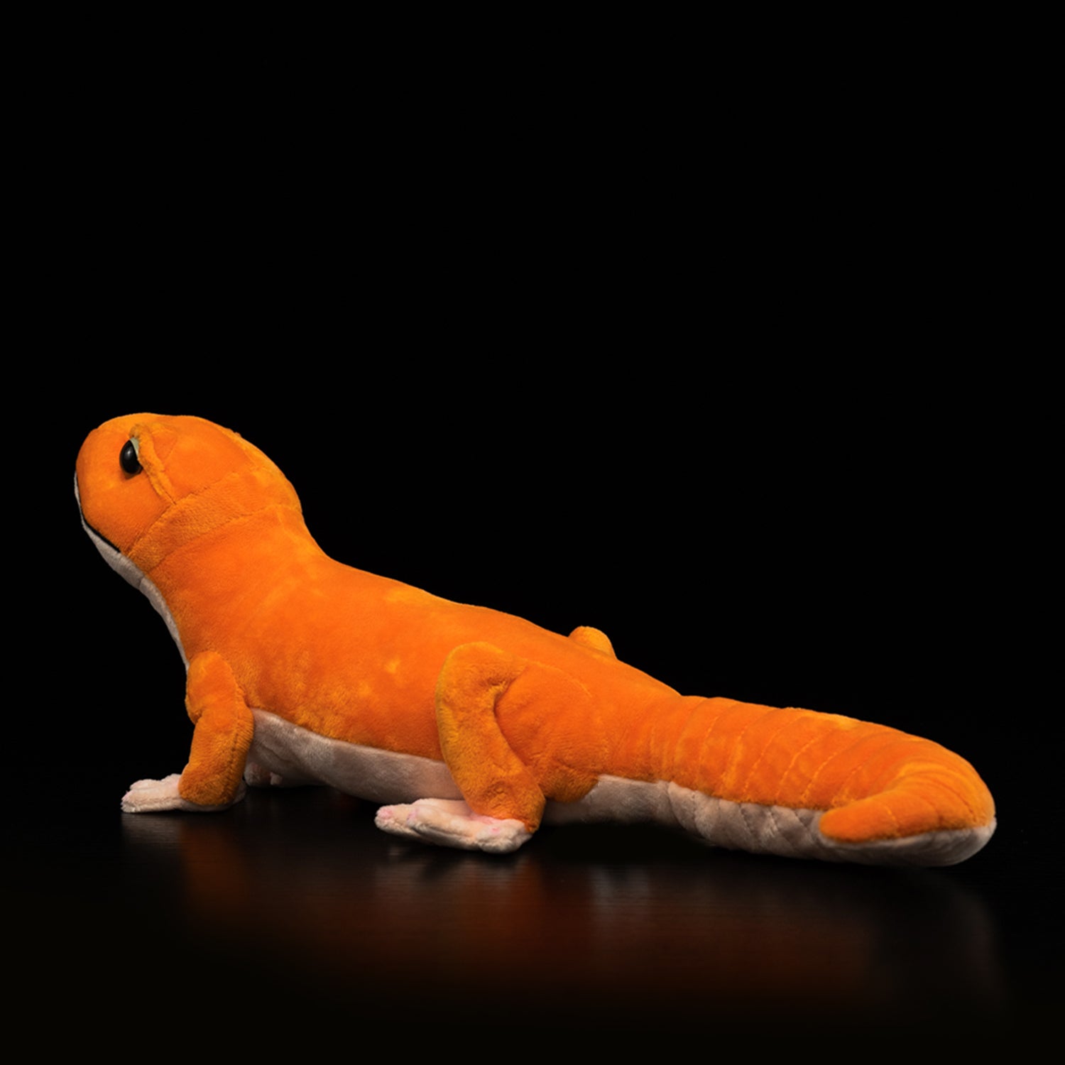 Side view of the Amel Patternless African Fat-Tailed Gecko Plush, highlighting its soft texture and bold design
