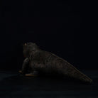 Rear view of lifelike Komodo dragon plush toy highlighting its detailed tail and textured skin