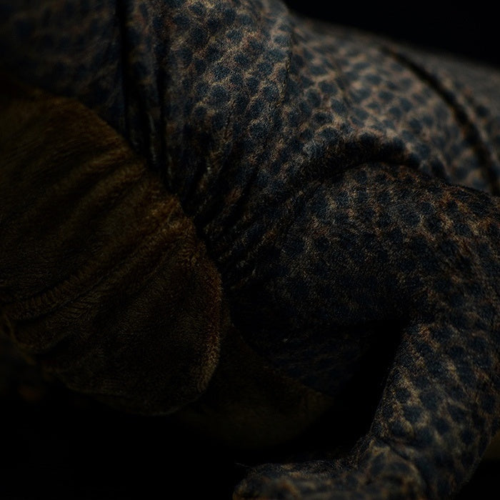 Close-up of the textured body of a Komodo dragon plush toy, showcasing lifelike details