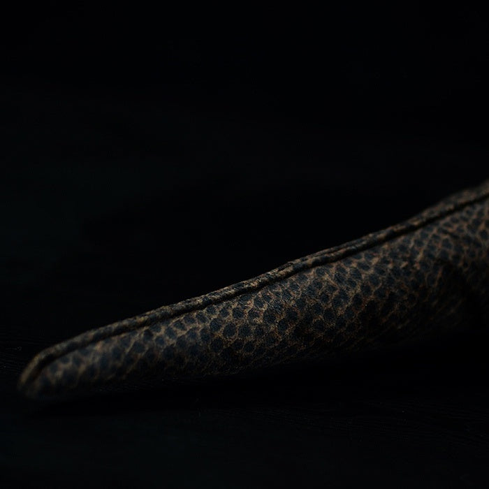 Close-up of the Komodo dragon plush toy’s tail, highlighting the scaly texture