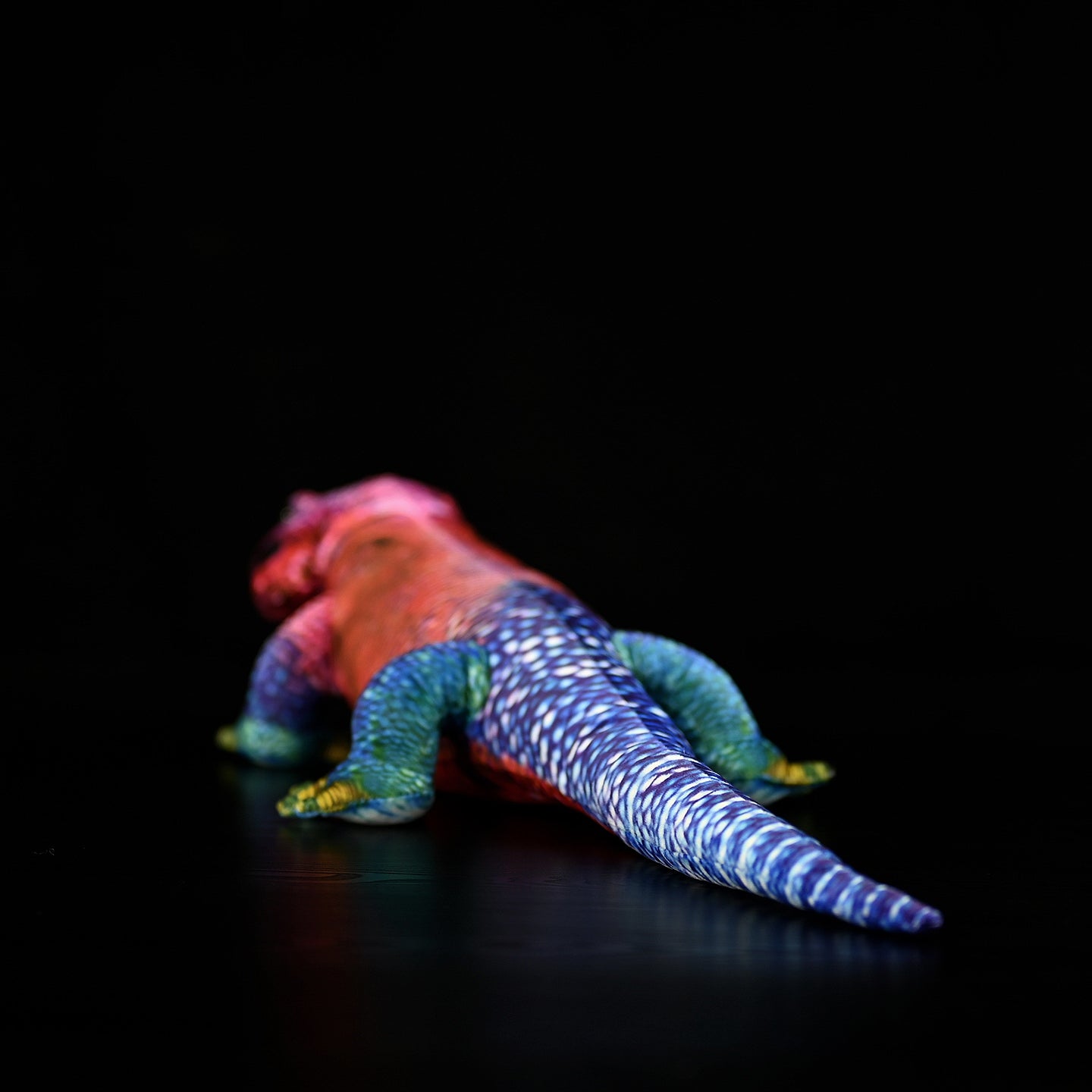 Rear view of the Spider-Man Agama plush showing its long, colorful tail with intricate blue and white patterns