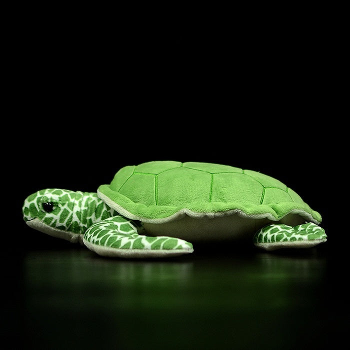 Side profile of the green sea turtle plush, featuring a soft shell and patterned flippers