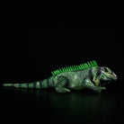 Side view of a detailed green iguana lizard plush featuring textured scales, vibrant green tones, and lifelike design