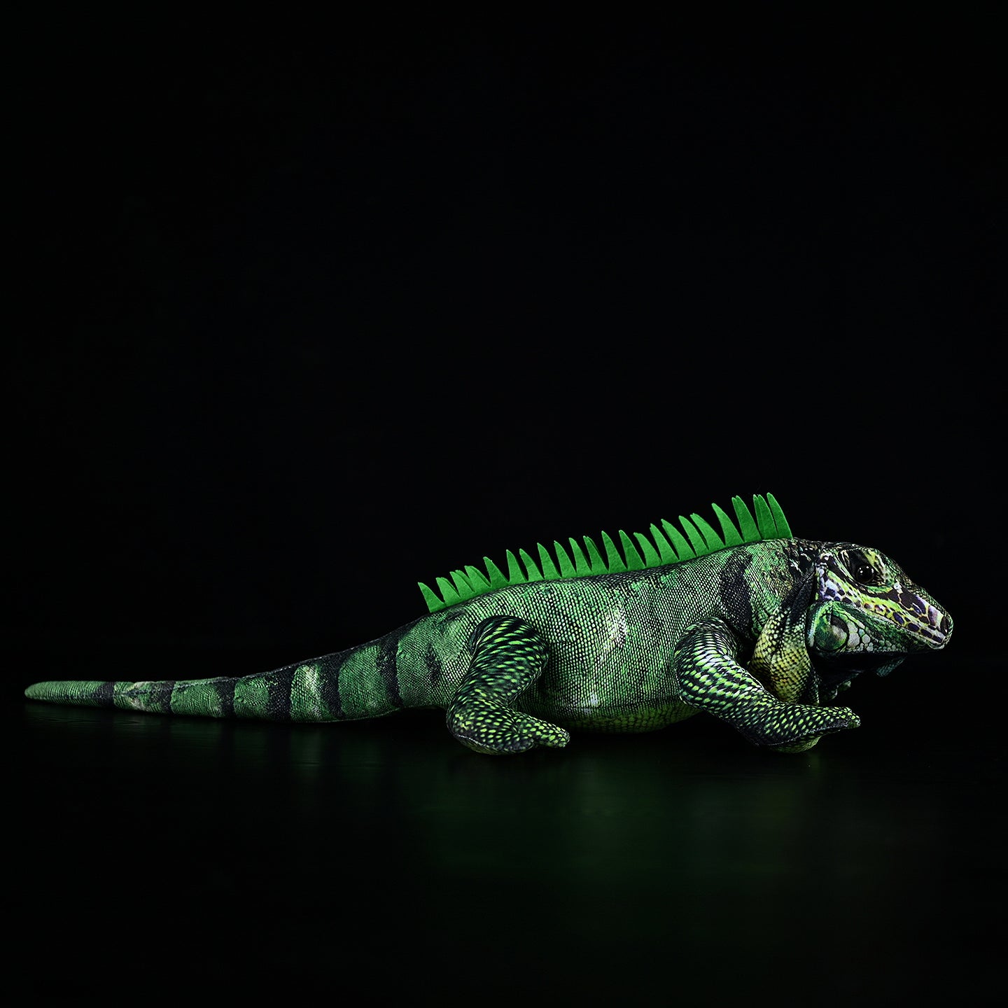 Side view of a detailed green iguana lizard plush featuring textured scales, vibrant green tones, and lifelike design