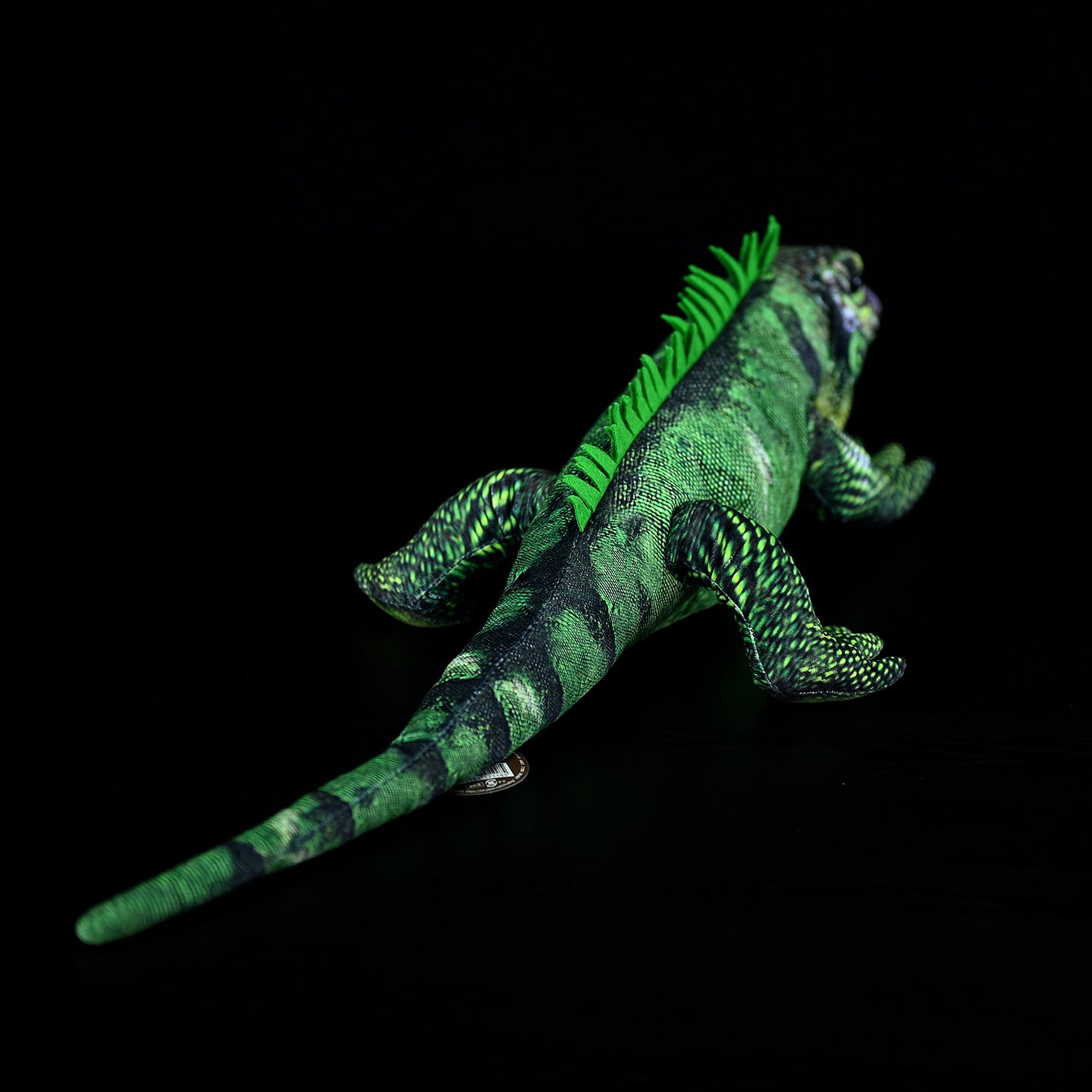 Vibrant green iguana plush in a crawling pose, highlighting its realistic texture and intricate coloration