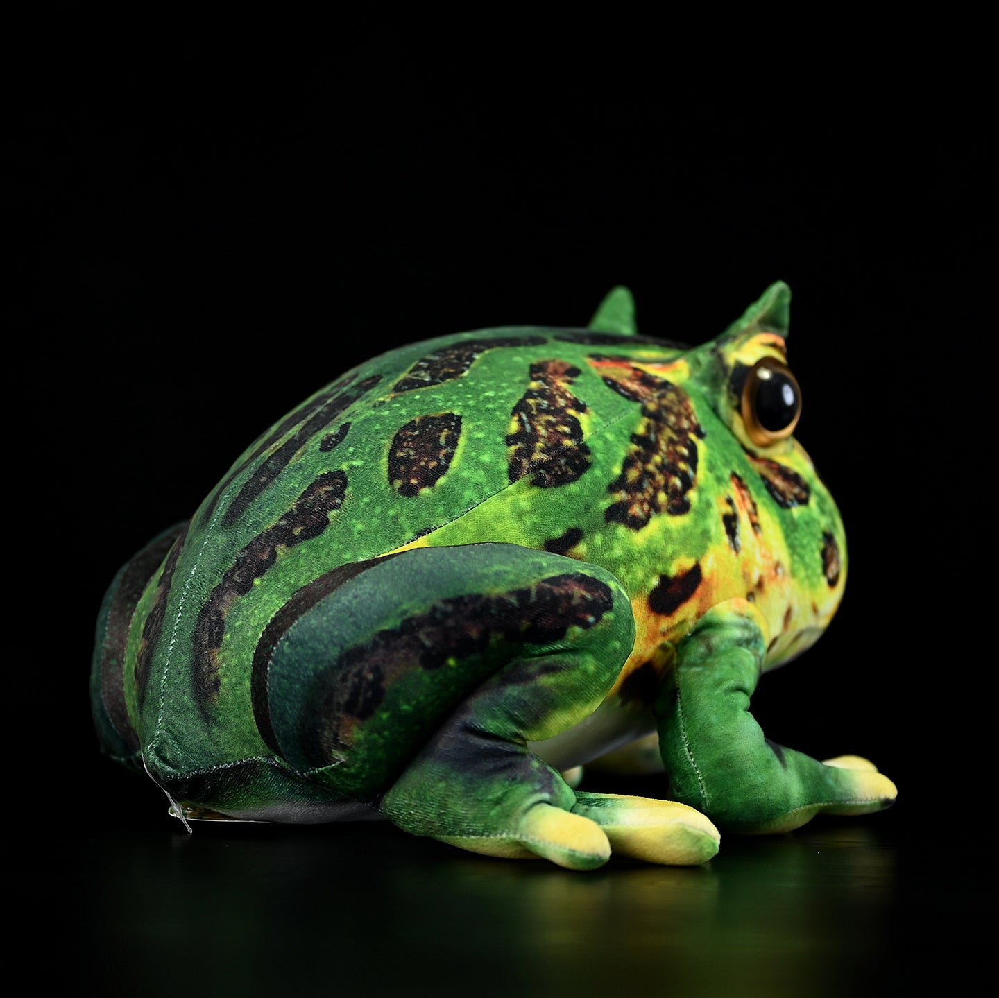 Rear side view of the lifelike Pacman Frog Plush showcasing its vibrant green tones and naturalistic details