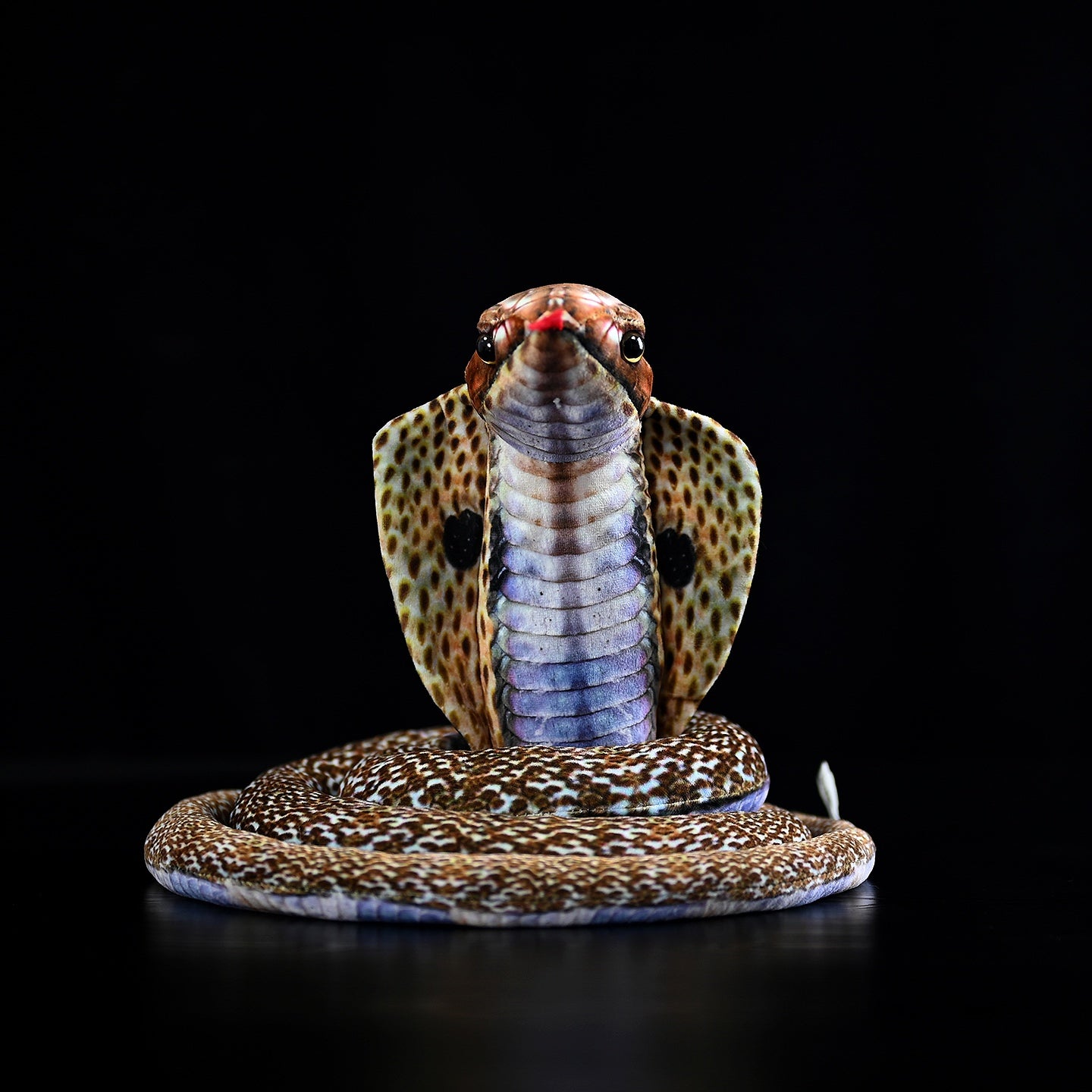 Front view of a lifelike monocled cobra plush toy showing its iconic hood pattern and realistic details