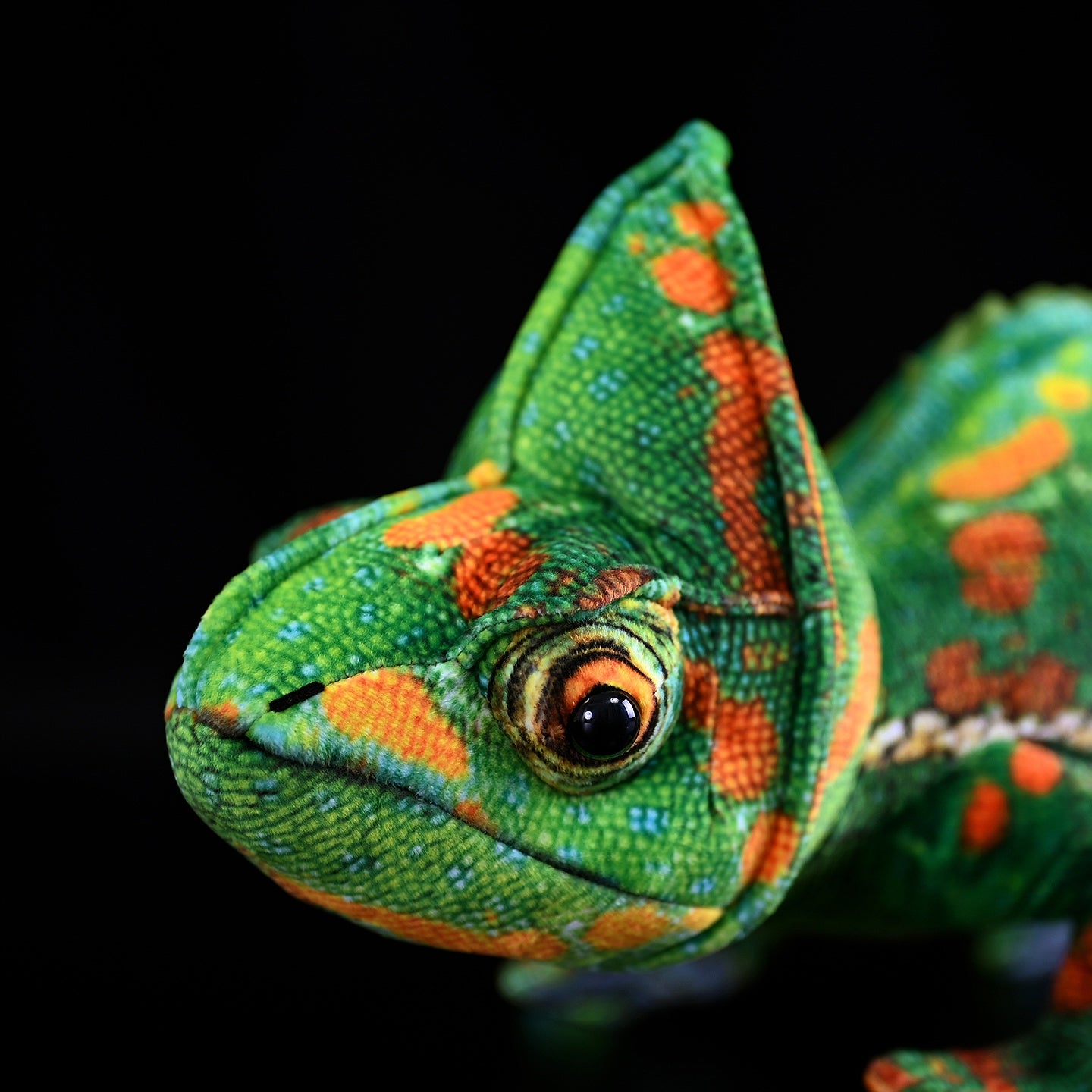 Close-up of the veiled chameleon plush’s realistic head and expressive eyes