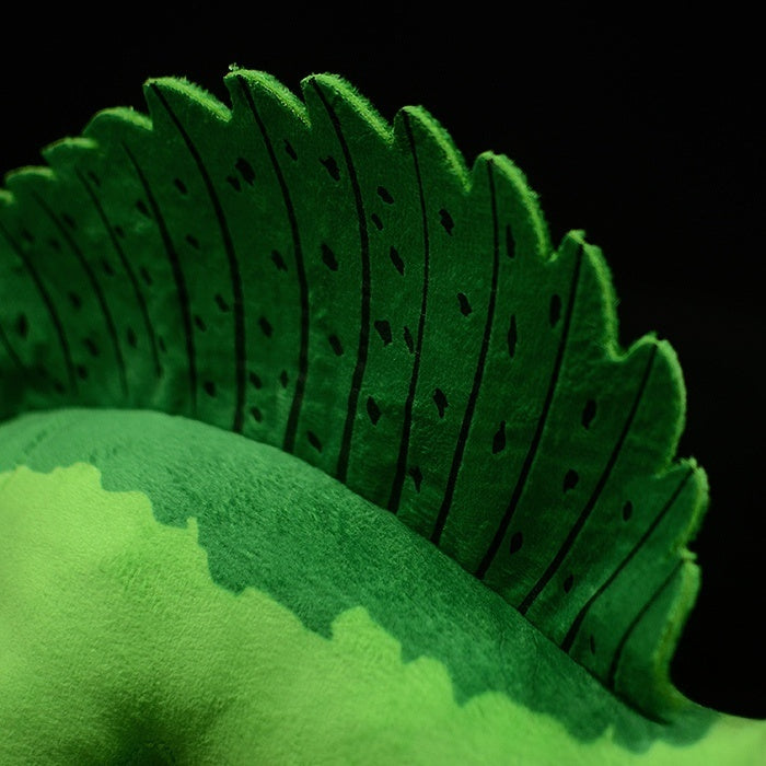 Close-up of Spinosaurus plush dorsal sail with detailed green patterns, soft texture, and lifelike design