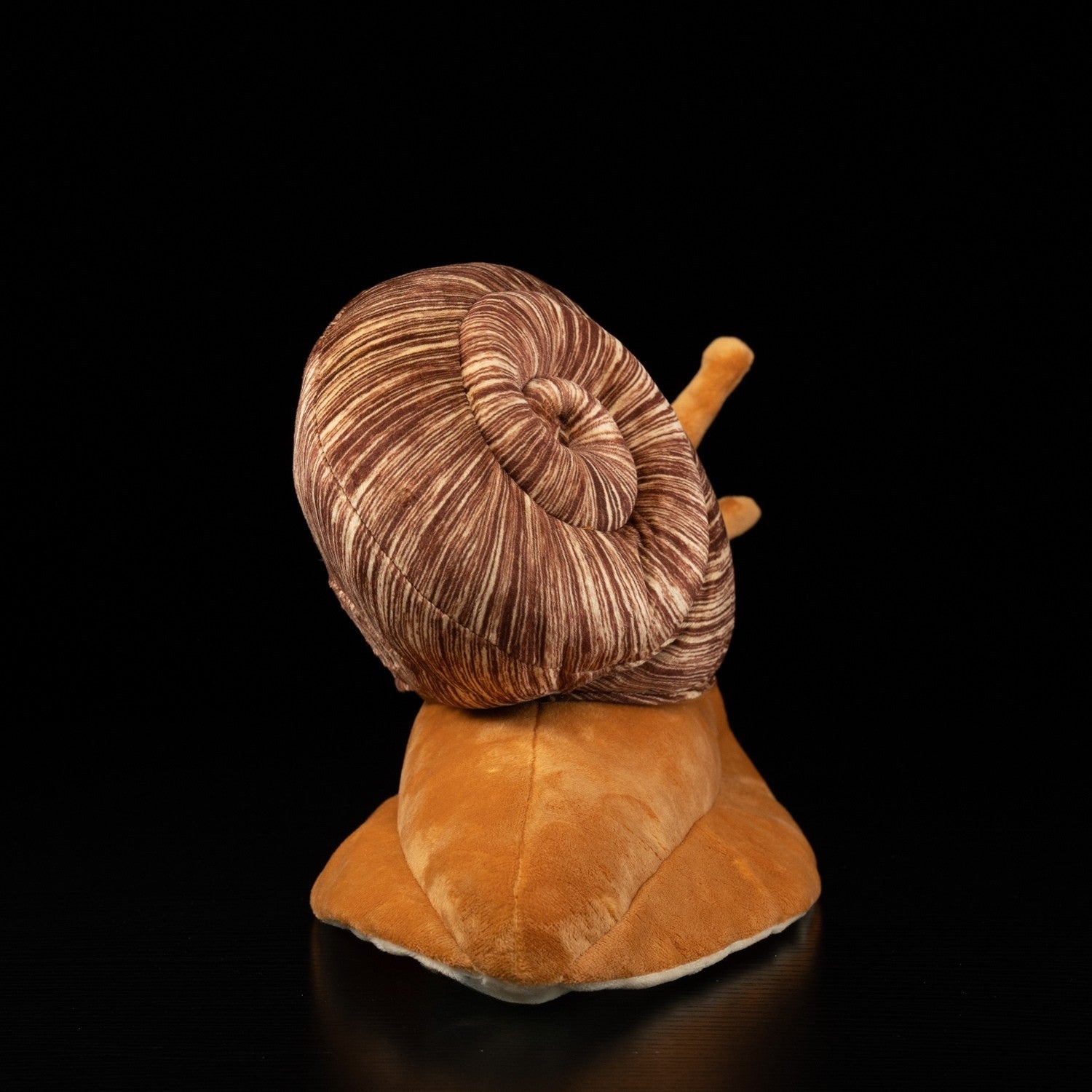 Back view of snail plush toy showcasing its spiral shell and smooth body by SoftDaysLab