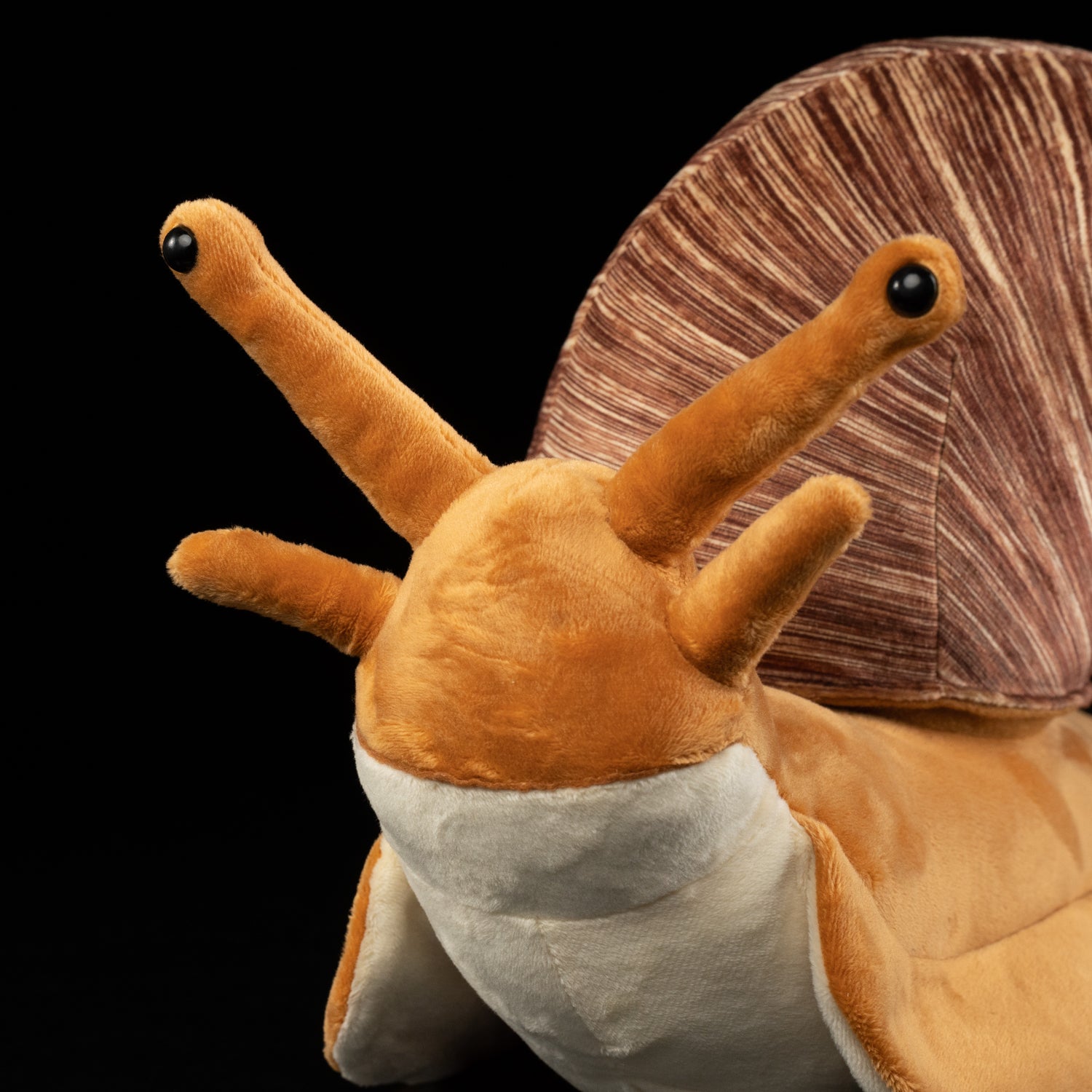 Close-up of snail plush toy's face with detailed antennae and lifelike expression by SoftDaysLab